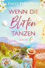 "Wenn die Blüten tanzen, Roman". Eine Frau mit Hut sieht ein alpines Tal mit Hütte und blühenden Bäumen.