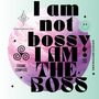 Großer, fetter Text: "I am not bossy, I am the boss!" Dahinter ein pinker Planet. Links oben ein spiralförmiges Symbol.