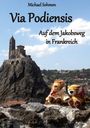 "Michael Sohmen - Via Podiensis - Auf dem Jakobsweg in Frankreich." Kirche auf Felsen, zwei Stofftiere sitzen vorne.