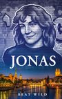 "JONAS" in großen Buchstaben und "BEAT WILD" darunter. Illustration eines Gesichts auf gemauerter Wand, darunter Stadtansicht.