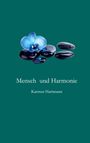 Text: "Mensch und Harmonie", "Karsten Hartmann". Eine blaue Blume liegt auf glatten, schwarzen Steinen vor grünem Hintergrund.