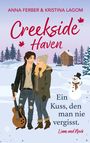 Titel: Creekside Haven. Untertitel: Ein Kuss, den man nie vergisst. Illustration: Paar im Winter, Schnee, Haus, Schneemann.