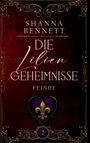 Text: "Shanna Bennett Die Lilien Geheimnisse Feinde". Verziertes Design mit lila Herz und goldener Lilie in der Mitte.