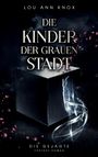 Text: "Die Kinder der grauen Stadt", "Die Gejagte", "Fantasy-Roman". Schwarzer Würfel mit leuchtenden Rissen und rosa Blättern.