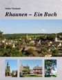 Oben steht "Heiko Theobald" und darunter "Rhaunen – Ein Buch". Darunter eine Stadtansicht mit Fachwerkhäusern und Kirchen.