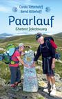 Carola und Bernd Ritterhoff, Titel "Paarlauf: Ehetest Jakobsweg". Zwei lachende Wanderer berühren einen mit Graffiti bedeckten Stein.