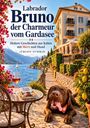 "Labrador Bruno der Charmeur vom Gardasee" oben, "Jürgen Schmid" unten. Hund liegt neben Tisch mit Wein am See.