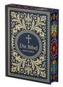 „Die Bibel nach Luther“ steht in goldener Schrift auf dunkelblauem Hintergrund mit kunstvollen Mustern und einem Kreuz.