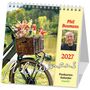 Kalender mit der Aufschrift „Phil Bosmans 2027“. Ein Fahrrad mit Korb voller Blumen, daneben ein Porträtfoto.
