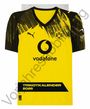 Vorderseite eines gelben Fußballtrikots mit schwarzem Muster, Logos und dem Text "vodafone" sowie "TRIKOTKALENDER 2026".