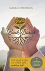 Text: "Sandra Leitermann", "Back to Basics", "Finde zurück zu dem, was wirklich zählt ... zurück zu DIR!" Zwei Hände halten eine Blume.