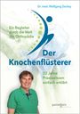 „Dr. med. Wolfgang Zeckey, Ein Begleiter durch die Welt der Orthopädie, Der Knochenflüsterer, 32 Jahre Praxiswissen einfach erklärt.“  
Ein Mann in grünem Hemd lächelt, im Hintergrund ein künstlerisches Logo.