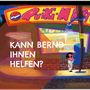 Text: "KANN BERND IHNEN HELFEN?" Vor einem Laden mit der Aufschrift "Quiki-Mart" steht eine Person an einer Telefonzelle.