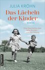 "Julia Kröhn, Das Lächeln der Kinder, Roman. Eine Geschichte über tiefe Wunden – und ihre Heilung." Zwei Kinder rennen glücklich.