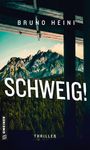 Texte: "BRUNO HEINI”, “SCHWEIG!”, “GMEINER”, “THRILLER”. Berge im Hintergrund, Holzbalken oben sichtbar.