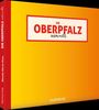"Die Oberpfalz wimmelt" in großen roten Lettern. Gelber Hintergrund mit rotem Rand, Buchrücken vertikaler Text.
