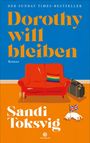 „Der Sunday Times-Bestseller: Dorothy will bleiben. Roman. Sandi Toksvig.“ Rotes Sofa, Koffer, Hund mit britischer Flagge.