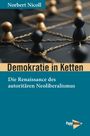 „Demokratie in Ketten“ von Norbert Nicoll. Goldene und schwarze Figuren sind mit Ketten verbunden. Unten PapyRossa-Logo.