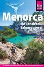 Reiseführer von Menorca, die "andere" Baleareninsel. Klare Bucht mit Badegästen und umgebender Vegetation.