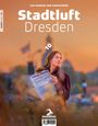 „Stadtluft Dresden“ in großer Schrift oben und „Das Bookzin zum Durchatmen“ darüber. Frau mit Zeitung im Sonnenuntergang.