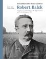 Zwei Jubiläumsalben für den Landdrost Robert Balck. Ein Schwarzweißfoto eines Mannes mit Brille und Schnurrbart.