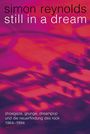 Text: "simon reynolds still in a dream. shoegaze, grunge, dreampop und die neuerfindung des rock 1984–1994 ventil". Hintergrund: Abstrakte, verschwommene rosa- und lila-Töne.