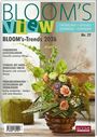 "BLOOM'S View" in großen Buchstaben, Thema: Frühling, Sommer 2026. Effektvolle Blumenarrangements in einem rustikalen Topf.