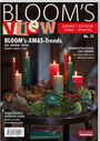 Titel: "BLOOM's VIEW", Ausgabenummer: 23. Dekorierter Adventskranz mit brennenden Kerzen und natürlichen Elementen.