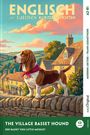 Englisch mit lustigen Kurzgeschichten. A2-B1. The Village Basset Hound. Ein Basset-Hund steht vor malerischen Häusern.