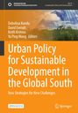 "Urban Policy for Sustainable Development in the Global South" in Orange. Wolken spiegeln sich in Glasfassade.
