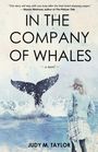 „IN THE COMPANY OF WHALES“ ~ a novel ~ Judy M. Taylor. Eine Person schaut auf eine Walfischflosse im Wasser.