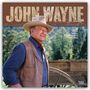 "JOHN WAYNE" und "2027 Official 16-Month Calendar". Mann in Cowboy-Outfit vor einem Wagenrad in einer ländlichen Szene.