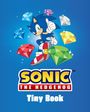 "Sonic The Hedgehog Tiny Book" in gelbem und weißem Text. Illustration von Sonic, umgeben von bunten Edelsteinen.