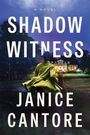 "Shadow Witness" und "Janice Cantore" in großen Buchstaben; Person in hellem Mantel geht auf beleuchtetes Gebäude zu.