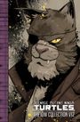 Text: "TEENAGE MUTANT NINJA TURTLES THE IDW COLLECTION V12". Illustration einer katzenartigen Figur mit Augenklappe.