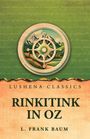 Text: LUSHENA CLASSICS, RINKITINK IN OZ, L. FRANK BAUM. Illustration: Kompassrose vor Berglandschaft, grüner Hintergrund.