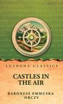 Oben steht "Lushena Classics". Darunter "Castles in the Air" von Baroness Emmuska Orczy. Illustration mit Kompass und Bergen.