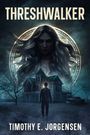 "THRESHWALKER" über einer mystischen Frau und einem Mann vor einem alten Haus. Unten steht "TIMOTHY E. JORGENSEN".